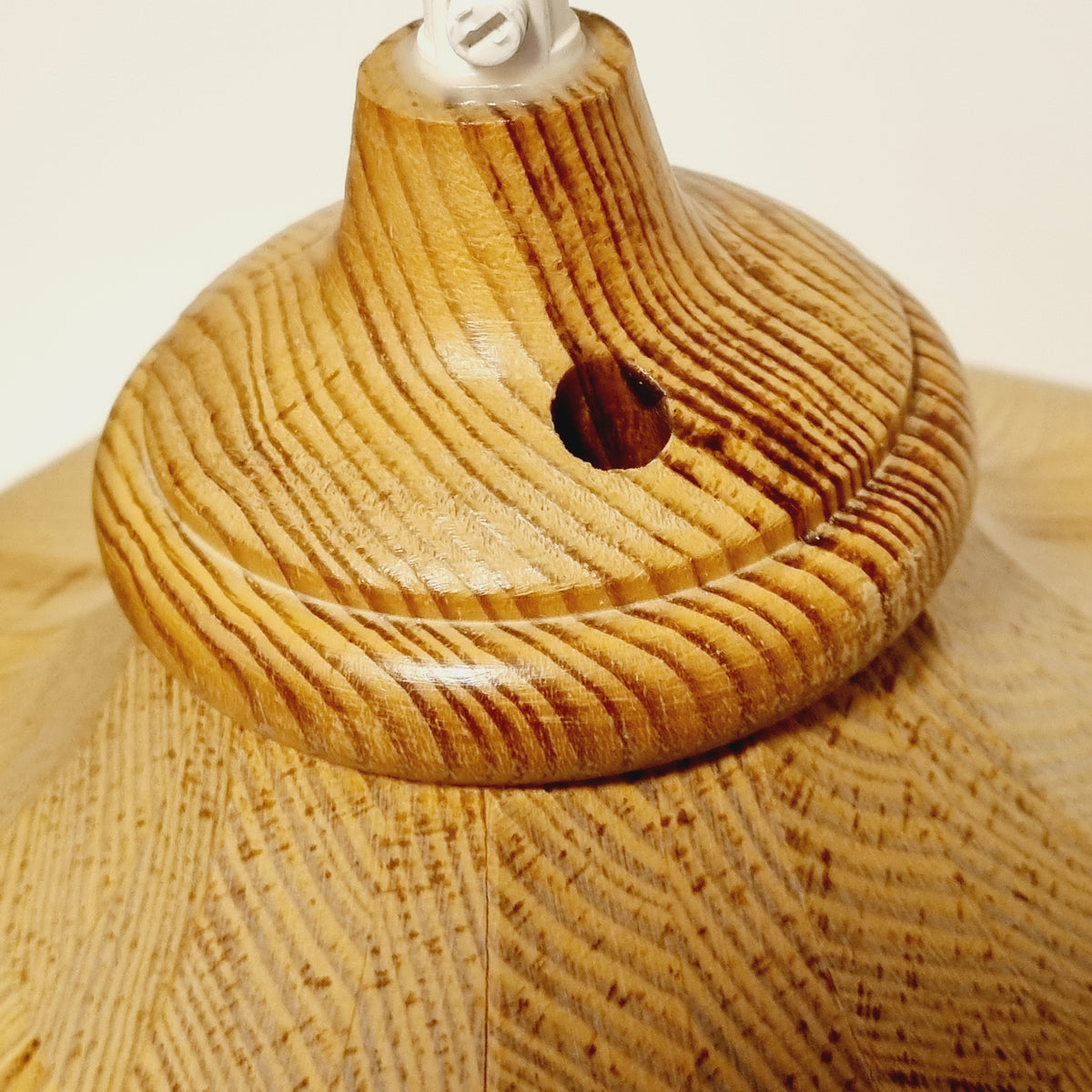 Close-up of the wood grain on the vintage Scandinavian pine hanging lamp