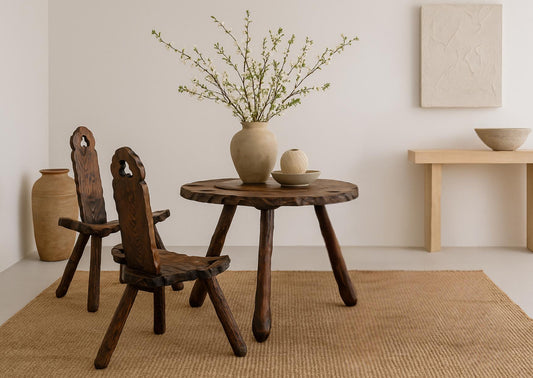 Rustic Wood Chair & Table - Sculptural Seating with a Folk Art Twist featuring a dark wood set with ceramic vases on a woven rug
