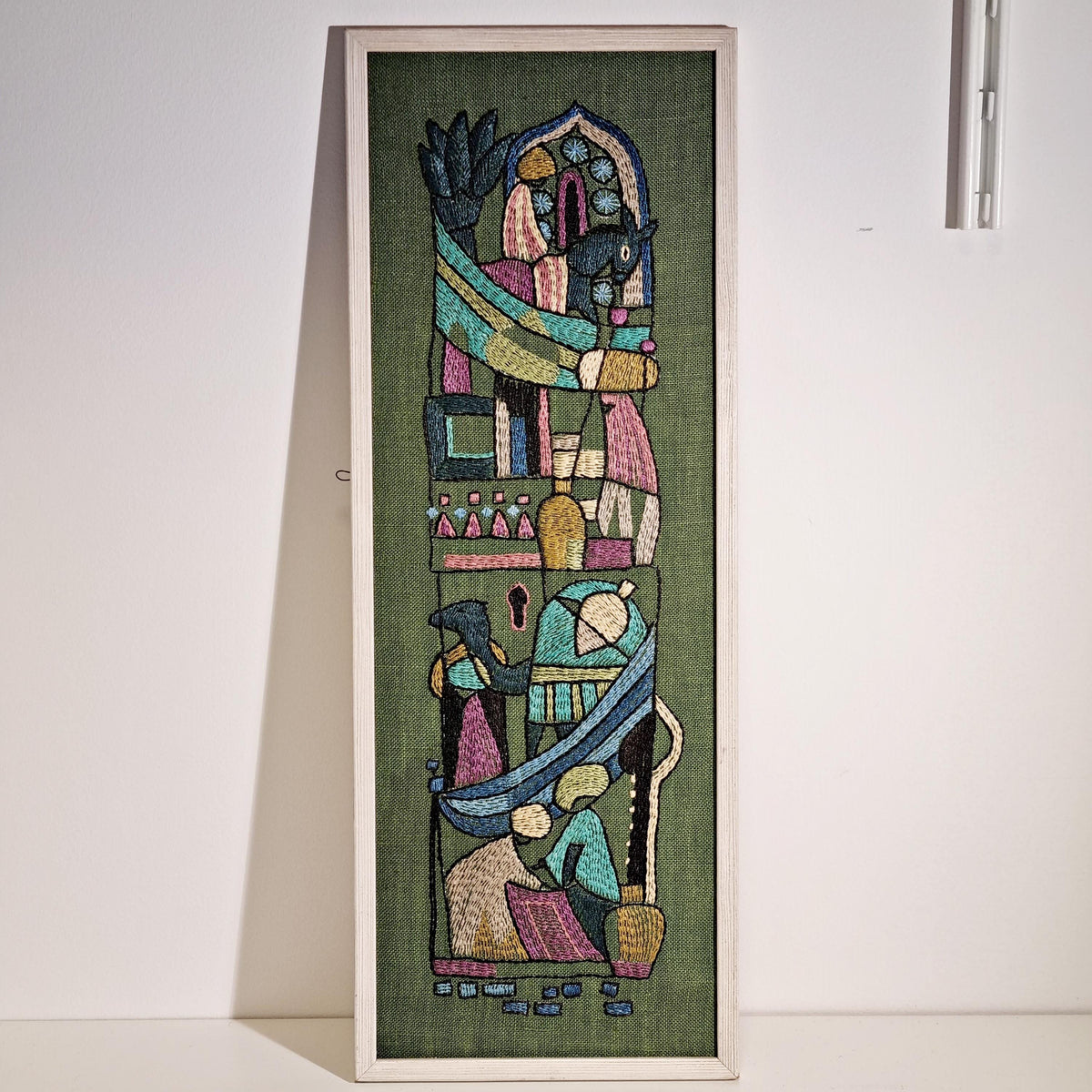 Framed Swedish folk art embroidery with figures and horses on olive green – photo 7