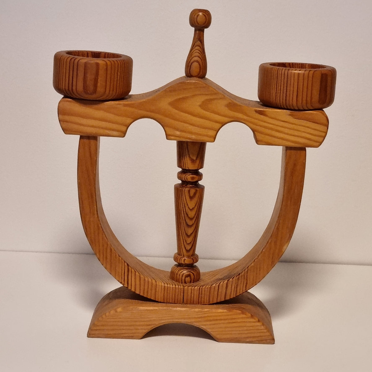 Turned center column and candle cups of Swedish pine candle holder