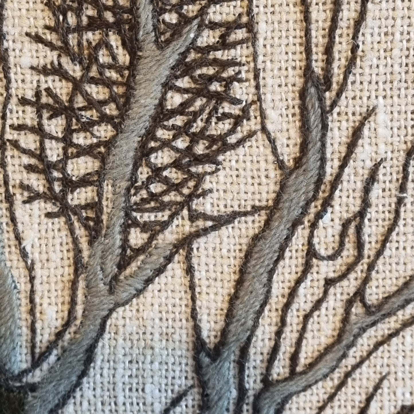 Close-up detail of white farmhouse with grey roof and frozen lake in foreground, Swedish embroidery