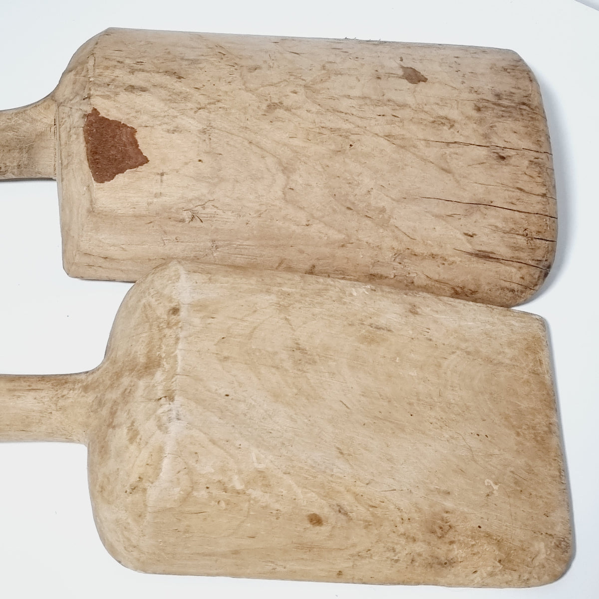 Backs of the two antique Swedish wooden scoops showing tool marks