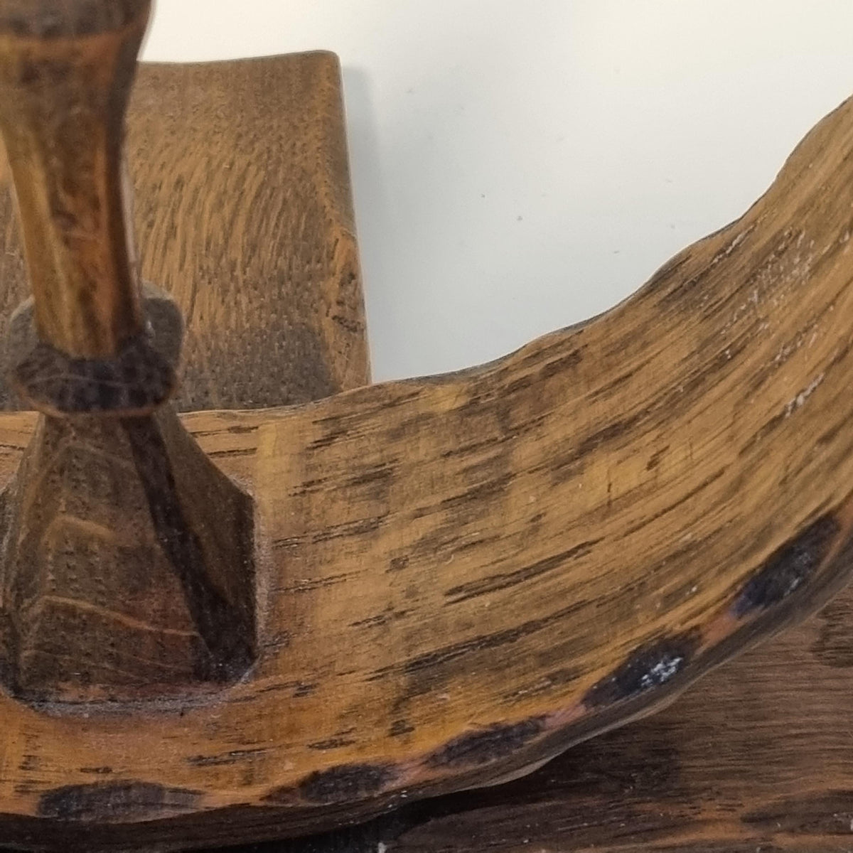a close-up view of a wooden surface with a textured, weathered appearance.