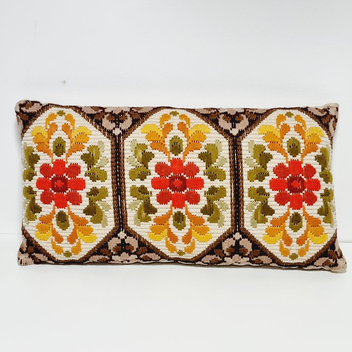 Vintage lumbar pillow with three embroidered floral panels in red, yellow, olive green and brown