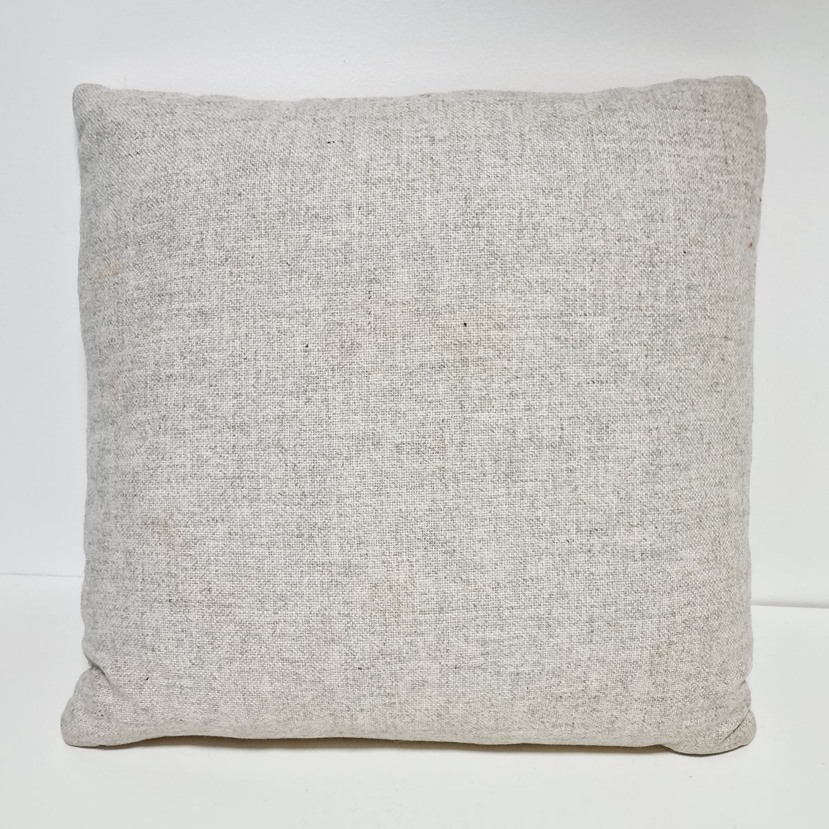 Plain light beige fabric back of the square embroidered pillow