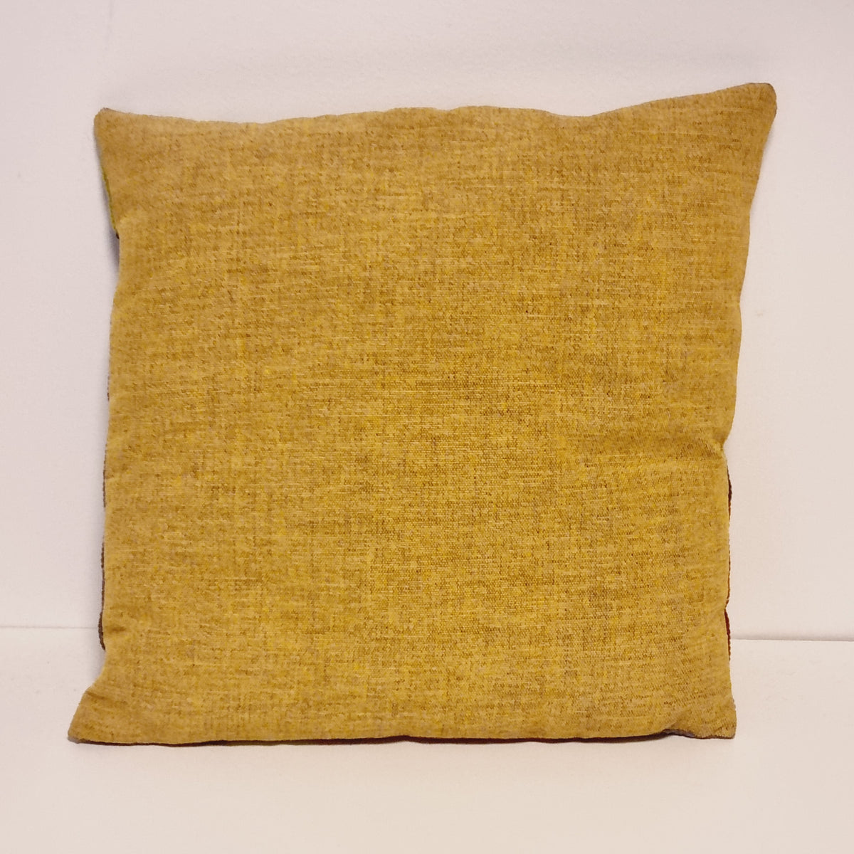 Plain mustard yellow fabric back of the miniature horse pillow