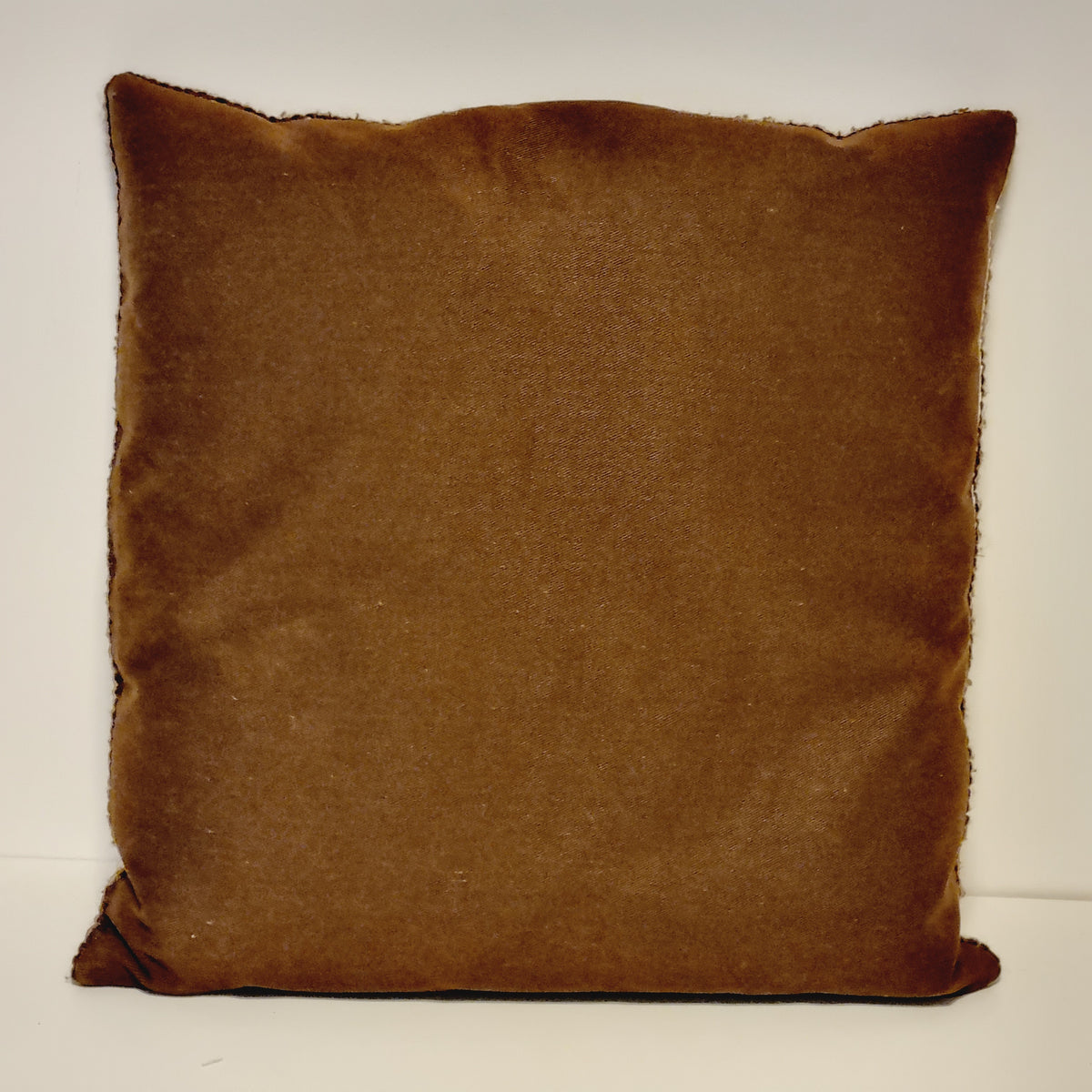 Plain warm brown fabric back of the vintage rose needlepoint pillow