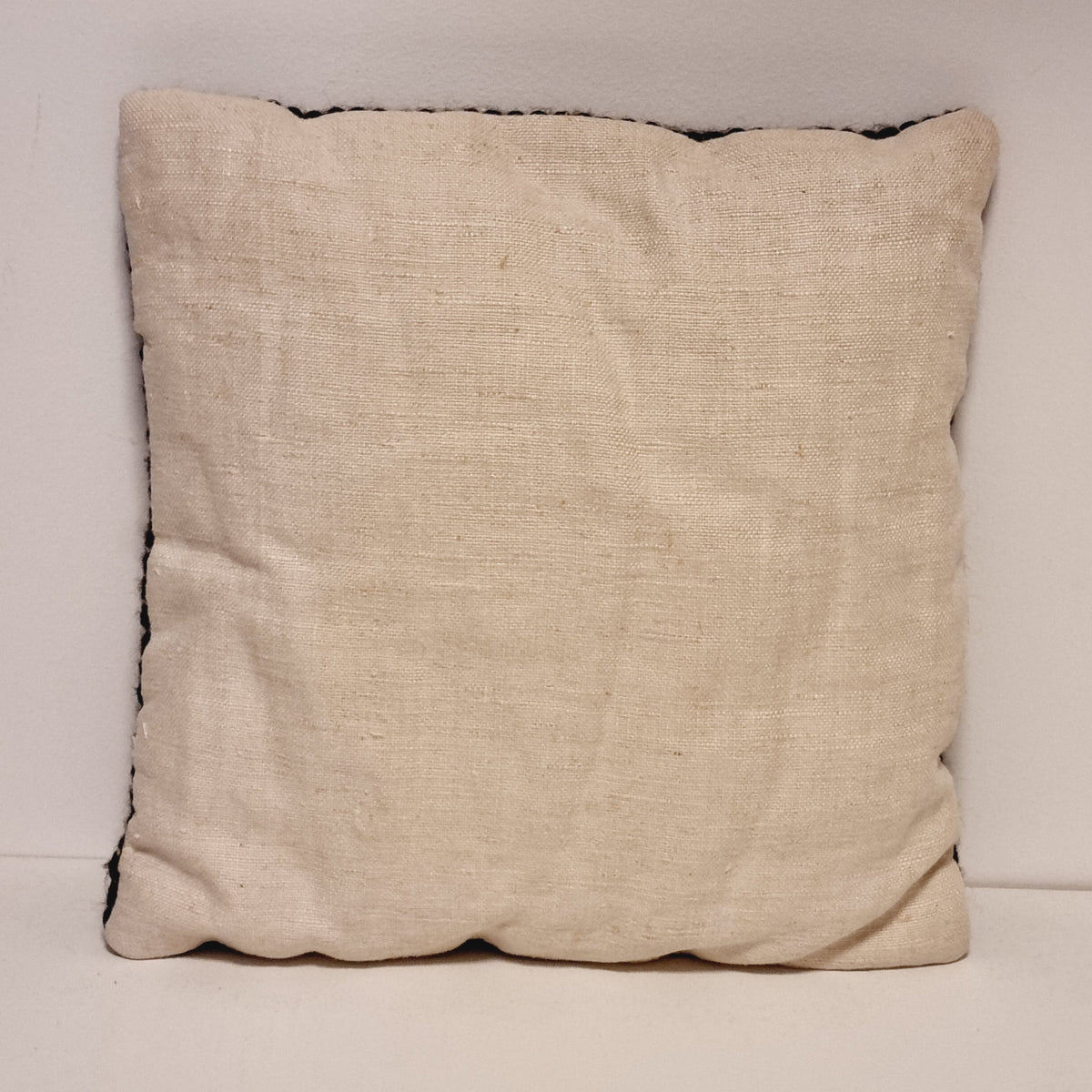 Plain cream fabric back of the vintage geometric pillow