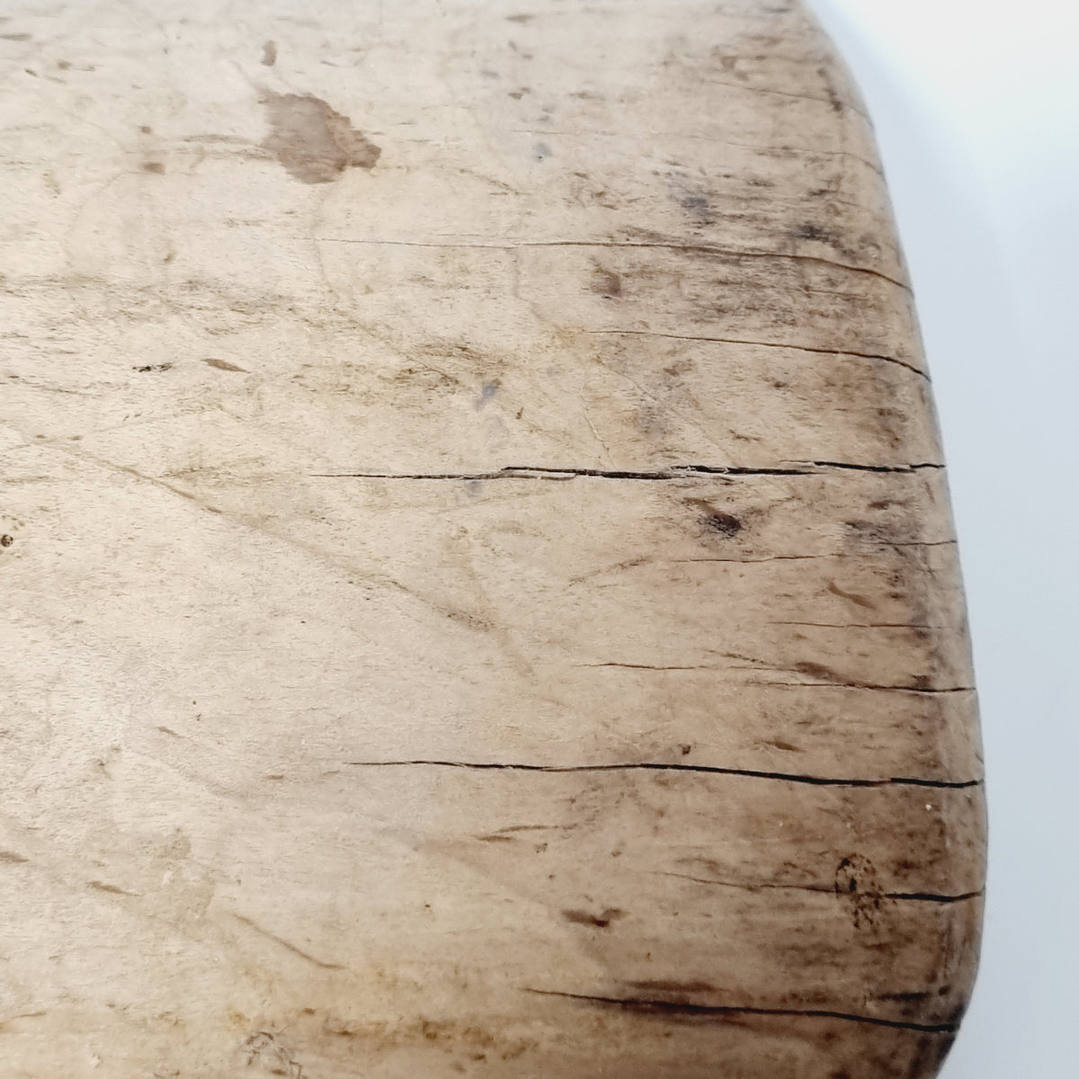 Close-up of cracks and grain on the back of the antique wooden scoop