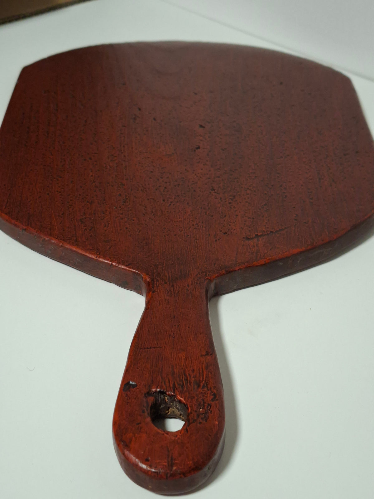 Antique Swedish Falu red bread board with handle, side view