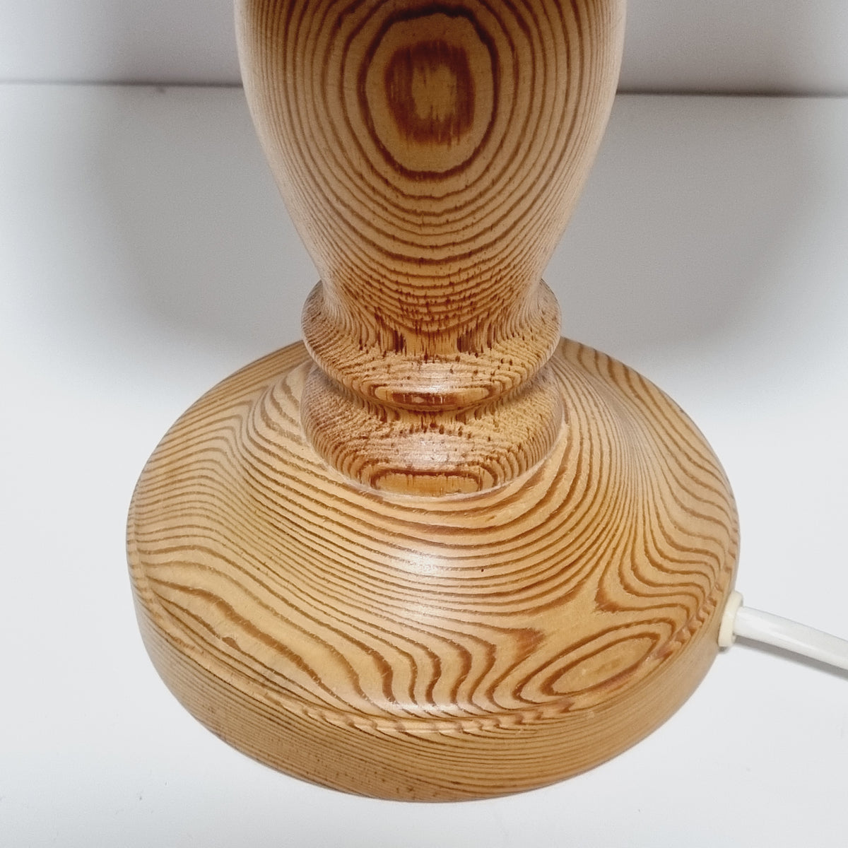 Close-up of concentric growth rings on end grain pine lamp shade