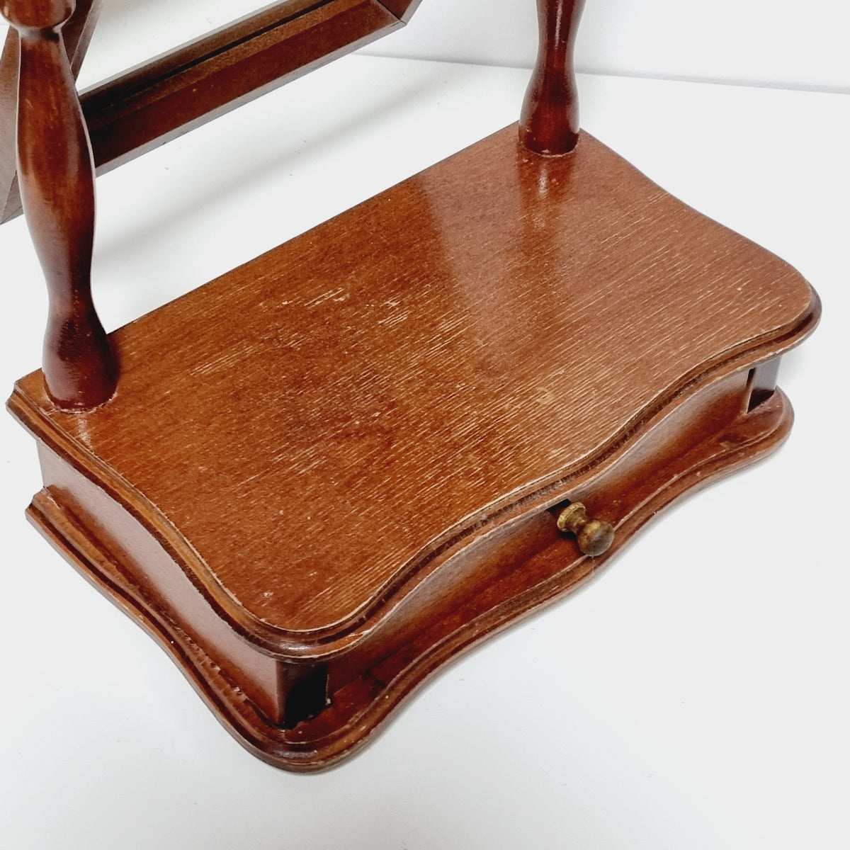 A wooden chair with a curved backrest and armrests.
