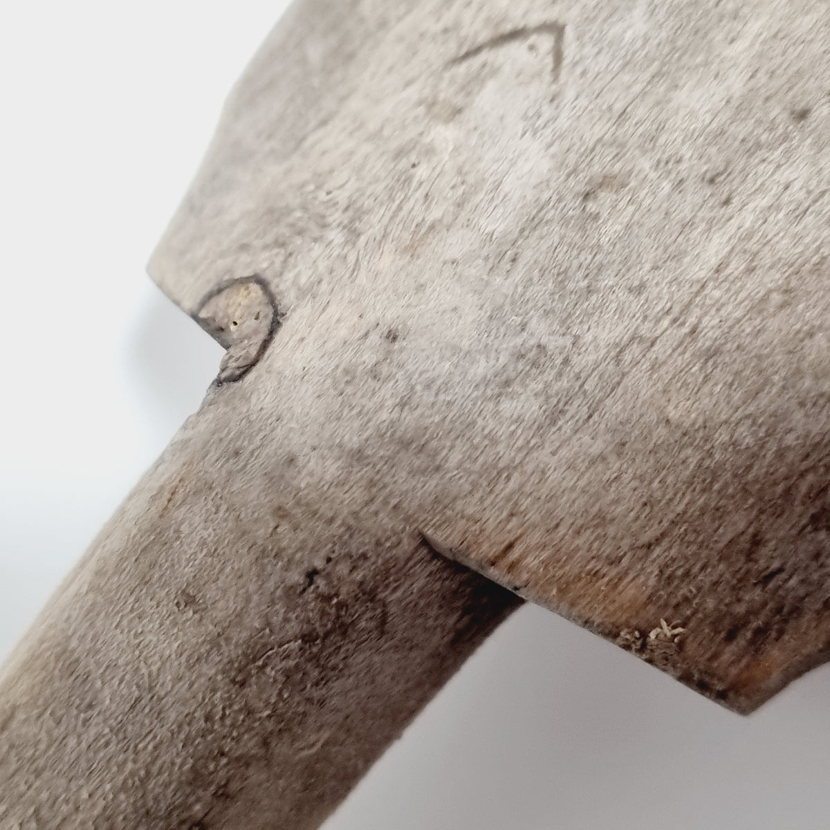 Close-up of the carved chevron owner's mark (bomärke) near the handle