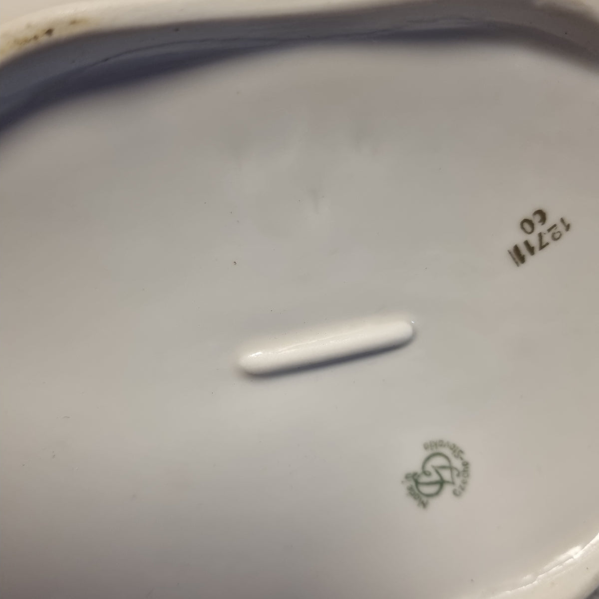 a close-up view of a white porcelain plate with some text and numbers visible.