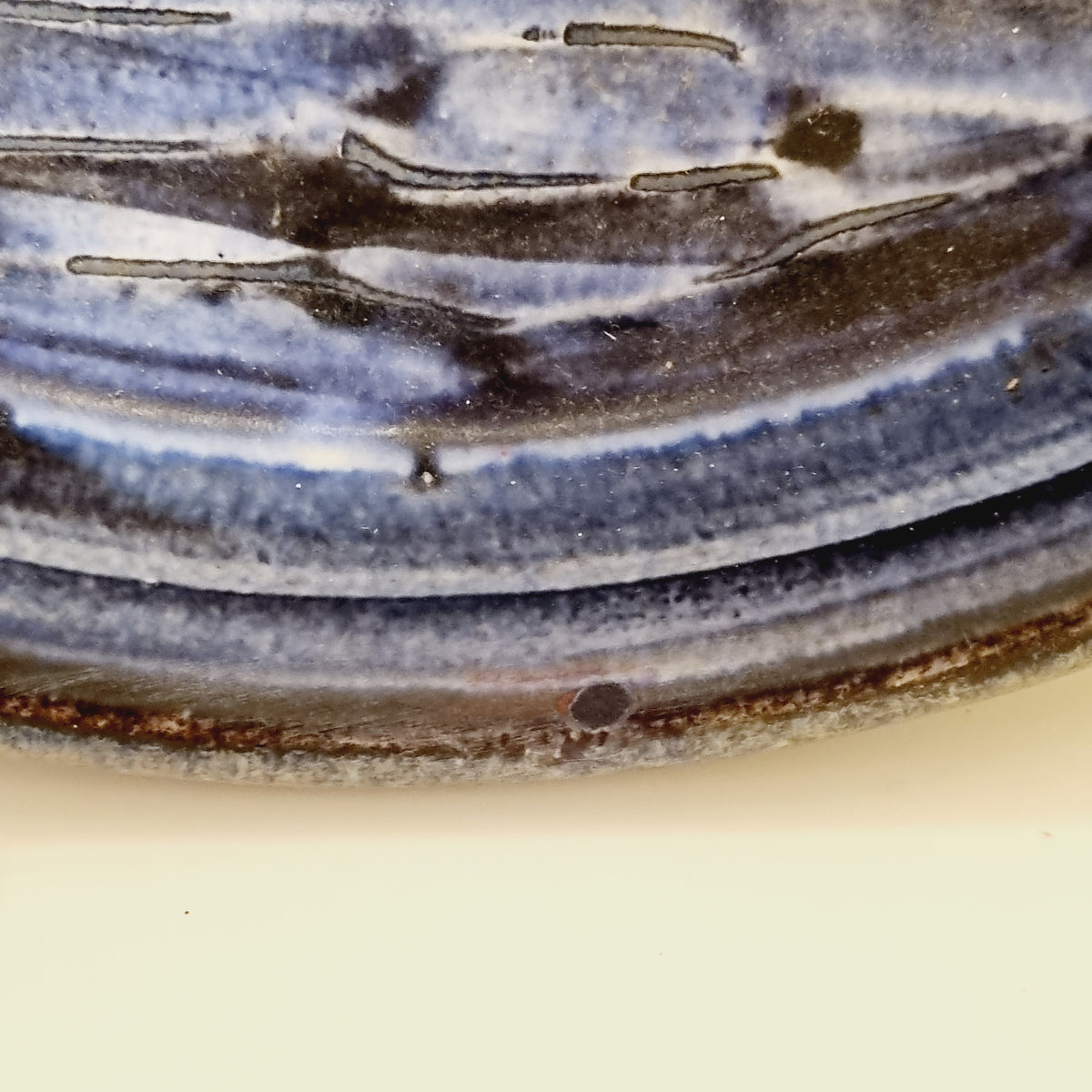 Rim detail of the Upsala Ekeby blue glazed wall plate