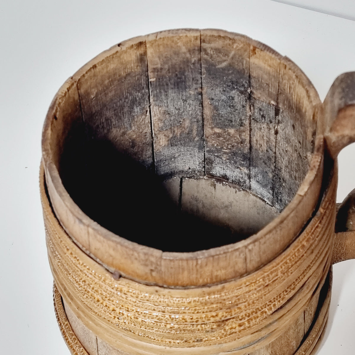 Dark aged interior of antique staved wooden tankard
