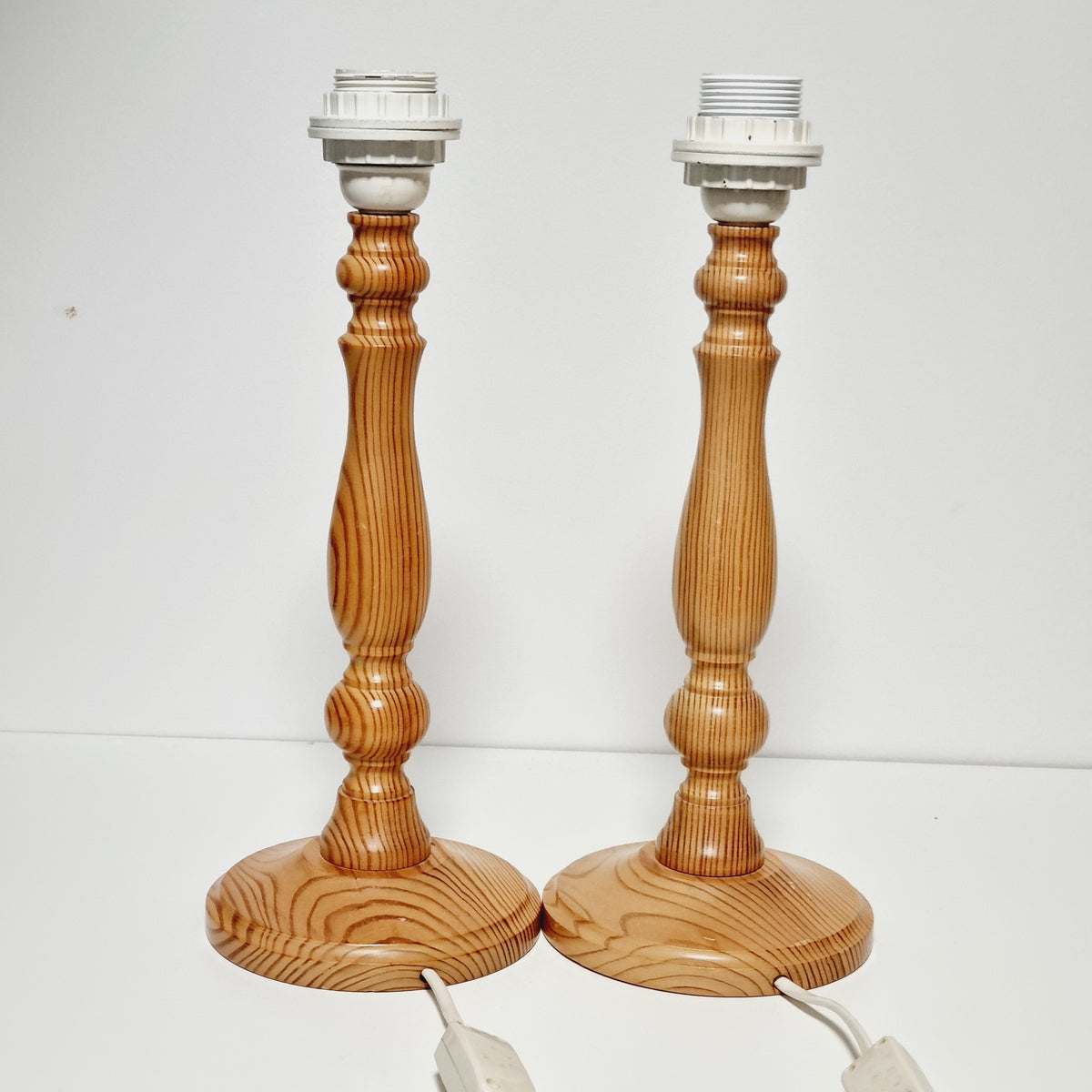 Pair of vintage Swedish pine lamp bases, angled view
