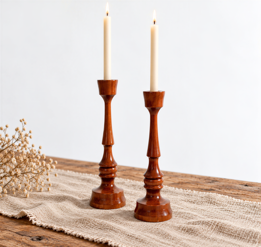 Pair of Scandinavian turned wooden candlesticks with lit taper candles
