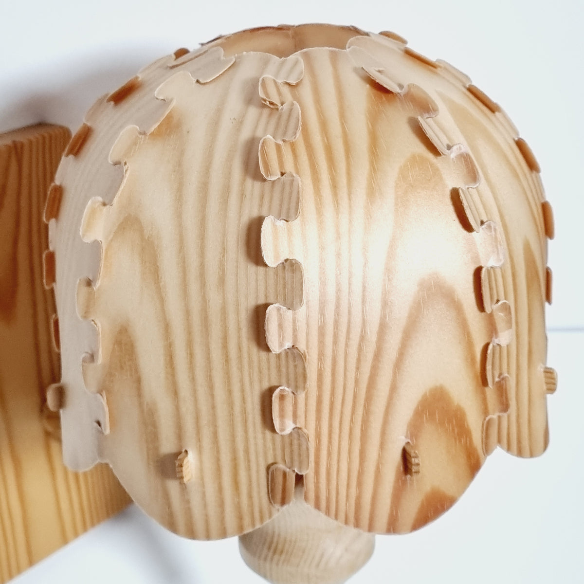 A wooden baseball cap with a textured, wood grain pattern.