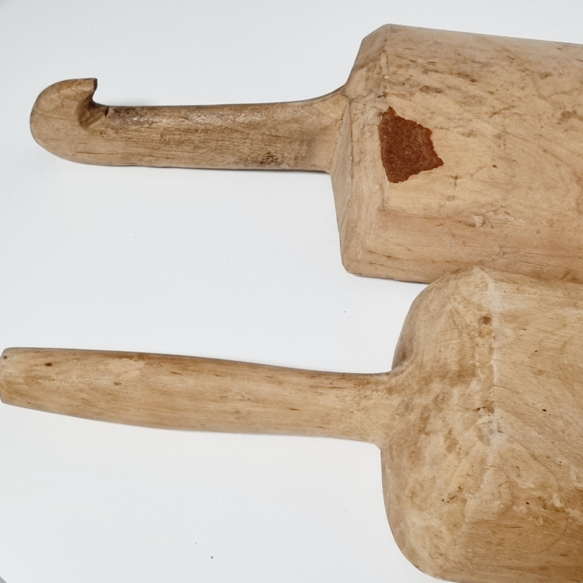 Handles of the antique scoops, one straight and one with a hooked end