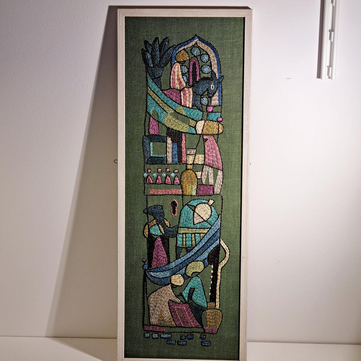 Framed Swedish folk art embroidery with figures and horses on olive green – photo 6