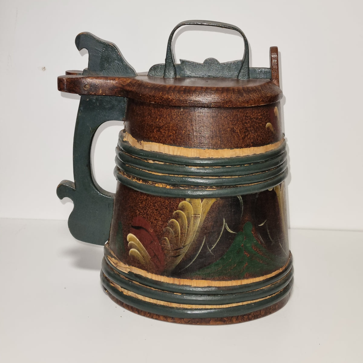 Rosemaling tankard with carved green handle, side view