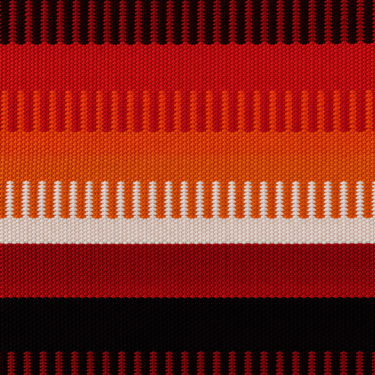 a vibrant, colorful, and textured pattern with alternating stripes of red, orange, and white. The pattern is composed of vertical stripes, creating a visually striking and dynamic design.