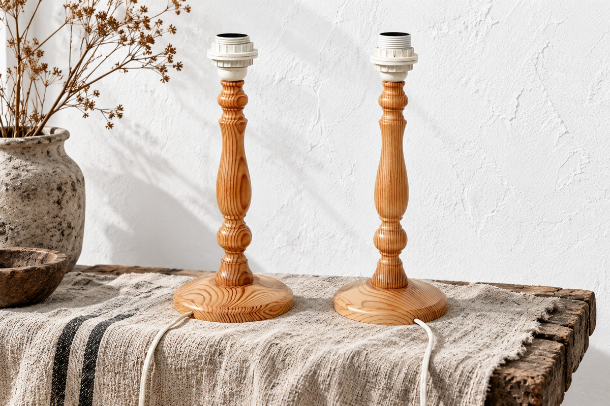 Pair of vintage Swedish turned pine table lamp bases styled on a table