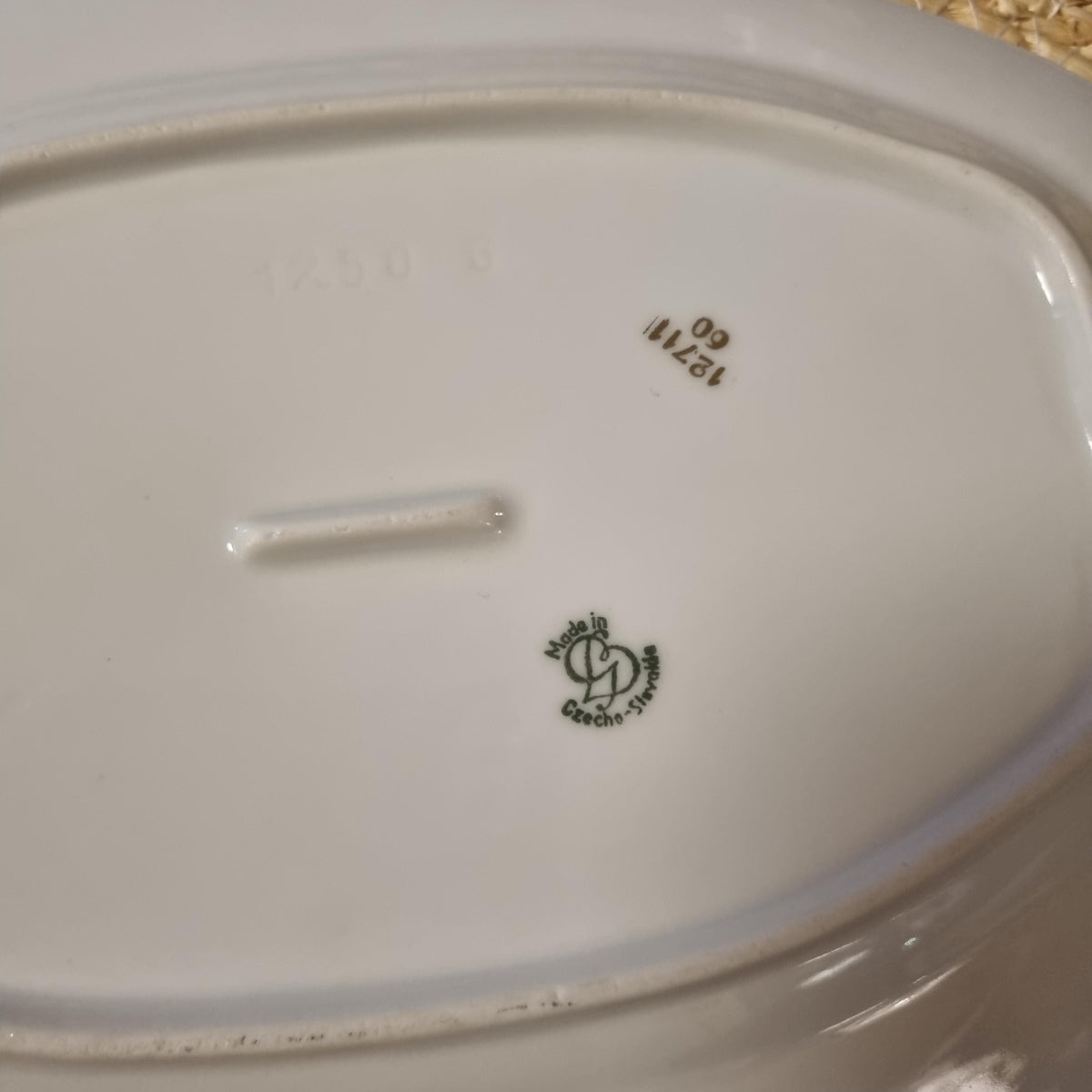 a close-up view of a white ceramic plate with some text and numbers printed on it.
