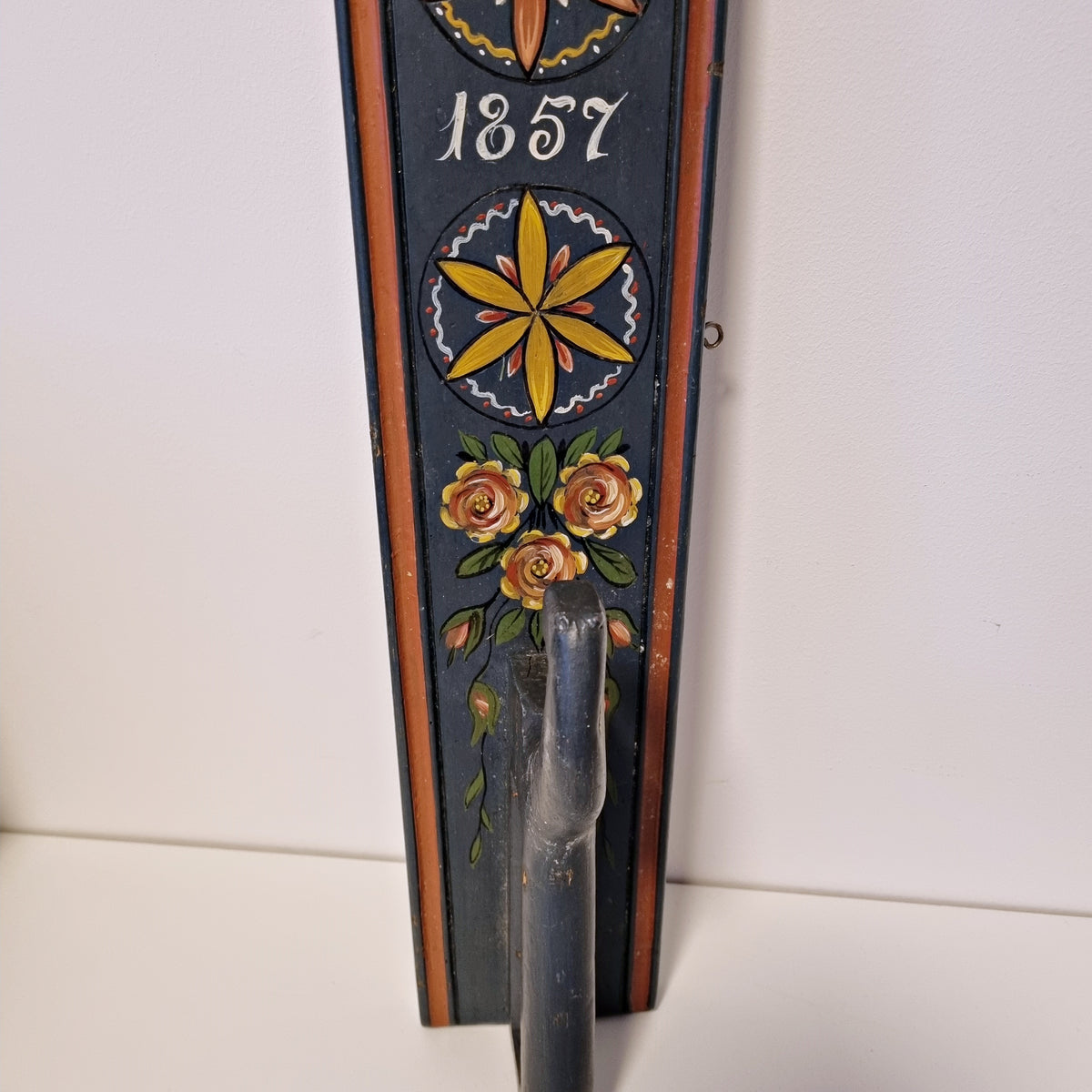 Painted rosettes, 1857 date and roses on antique Swedish folk art wall hook