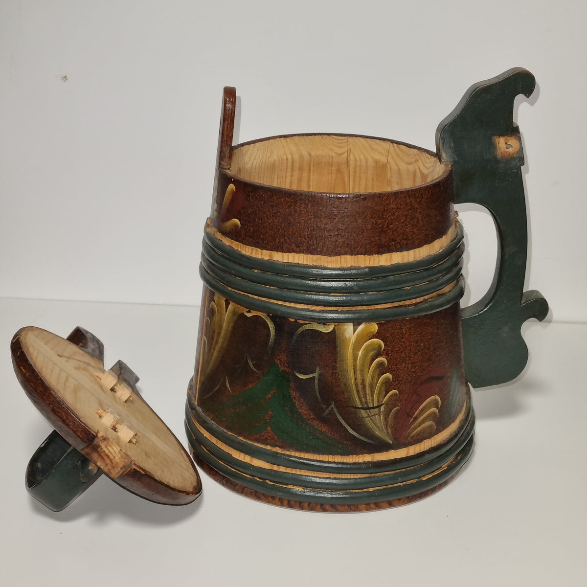 Vintage rosemaling tankard with green carved lid handle and thumb lever