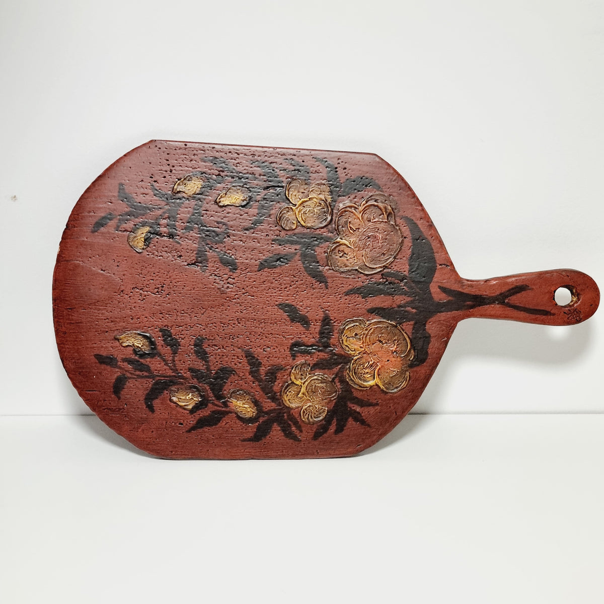 Antique Swedish bread board painted in Falu red with hand-painted golden flowers, front view
