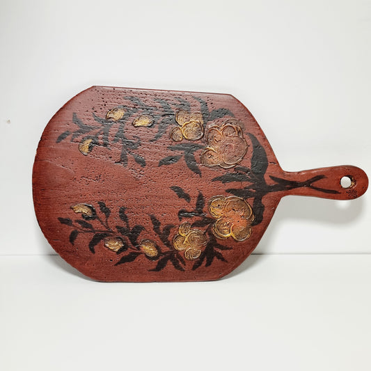 Antique Swedish bread board painted in Falu red with hand-painted golden flowers, front view