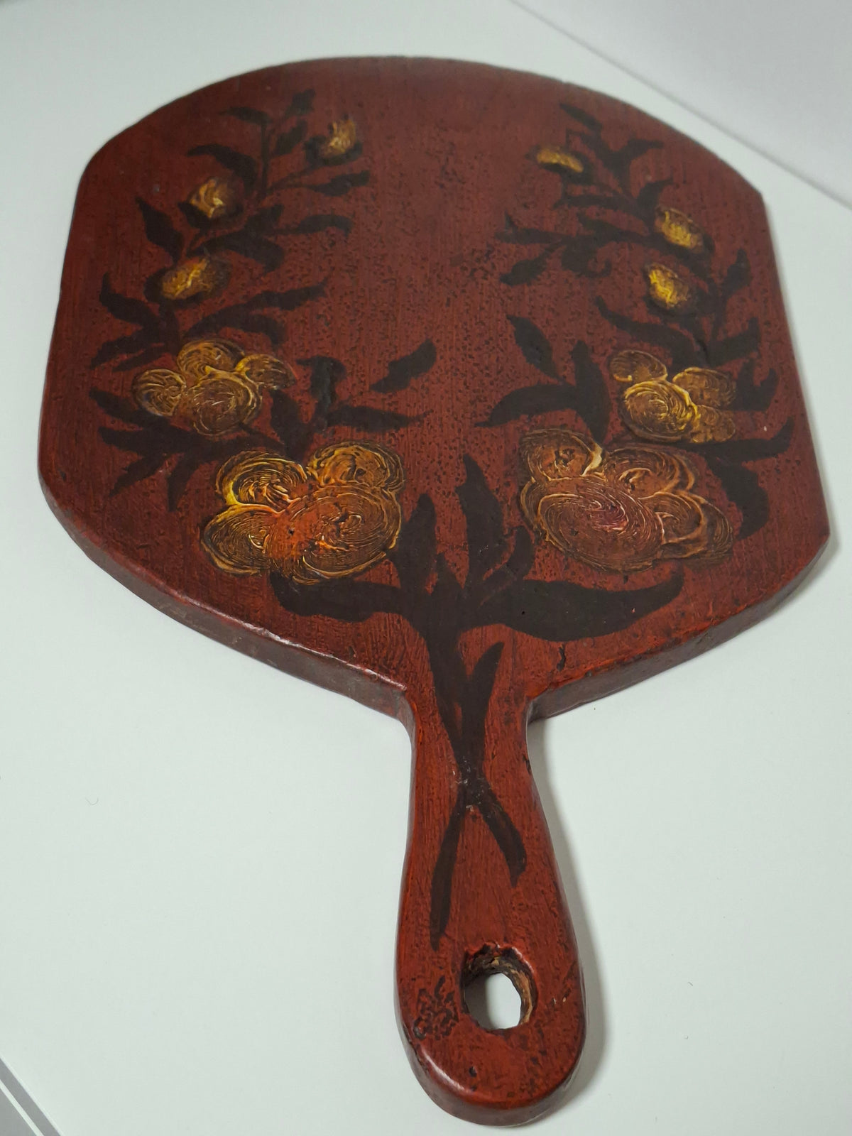 Hand-painted floral bouquet rising from the handle of the Swedish bread board