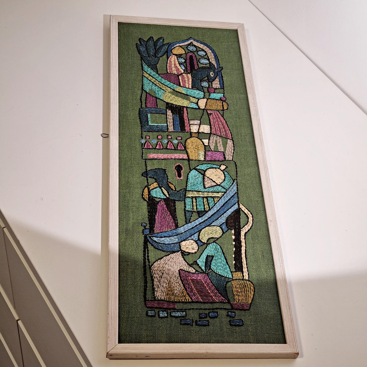 Framed Swedish folk art embroidery with figures and horses on olive green – photo 4