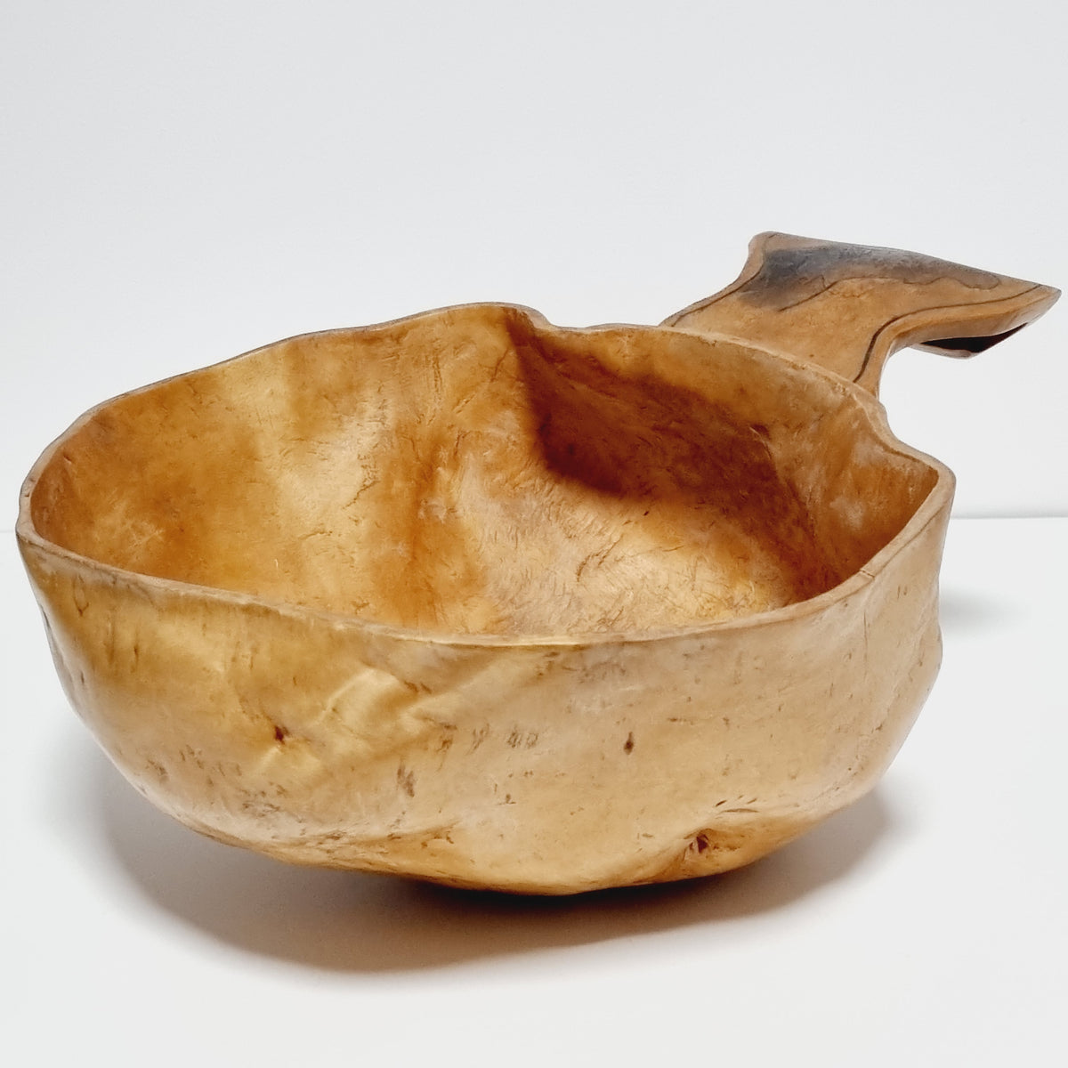 Underside of birch burl bowl showing flecked masur grain