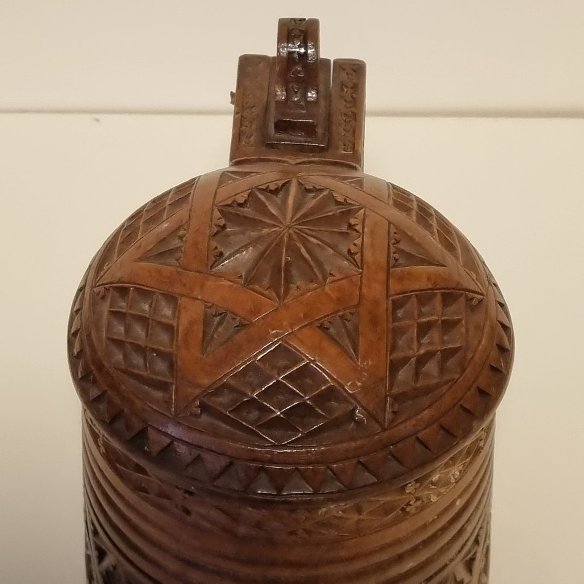 Chip carved star rosette on domed lid of antique wooden tankard