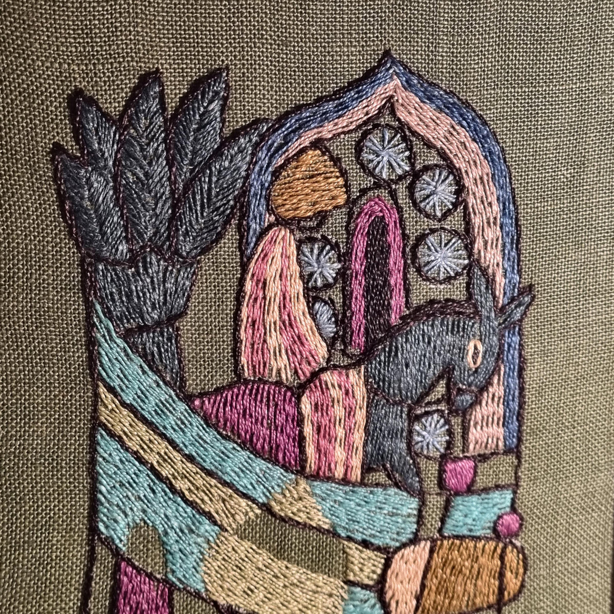Framed Swedish folk art embroidery with figures and horses on olive green – photo 3