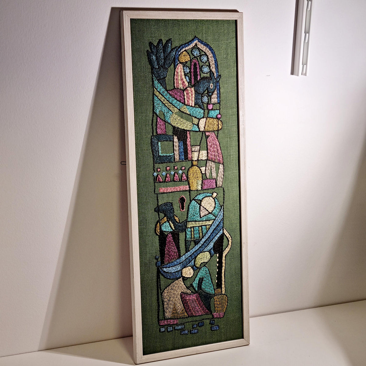 Framed Swedish folk art embroidery with figures and horses on olive green – photo 5
