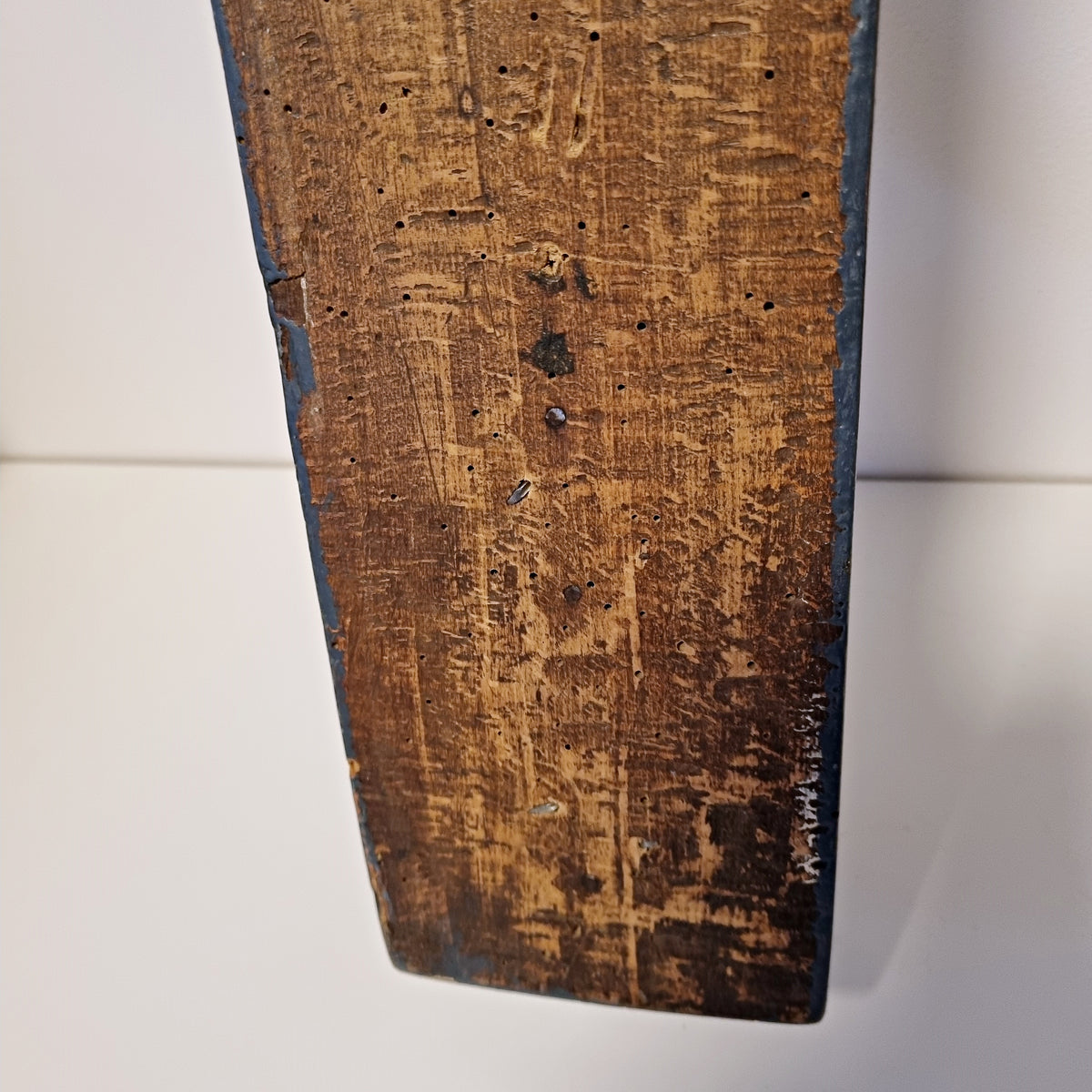 Close-up of aged wood and hand-forged nail heads on back of Swedish wall hook