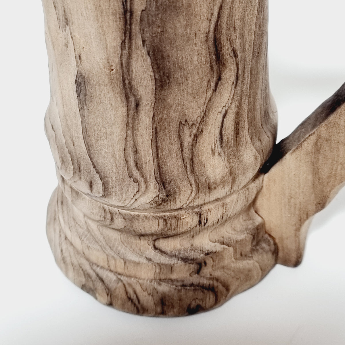 Flame-like grain on the body of hand carved wooden tankard