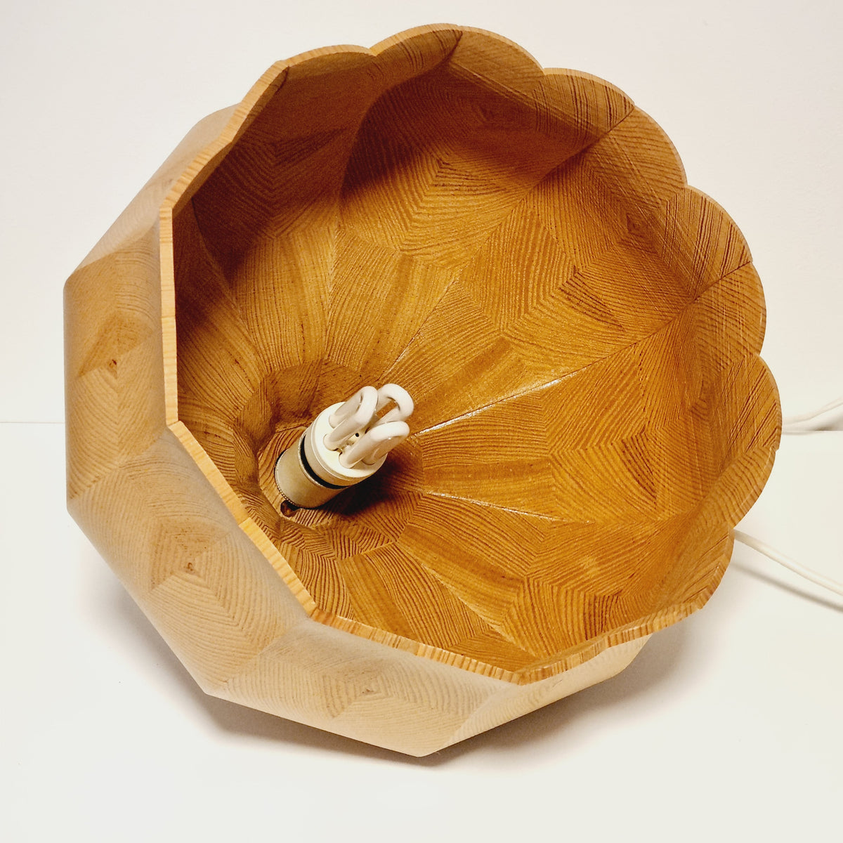 Inside of the segmented pine pendant shade, wood pieces radiating from the E27 socket to the scalloped edge