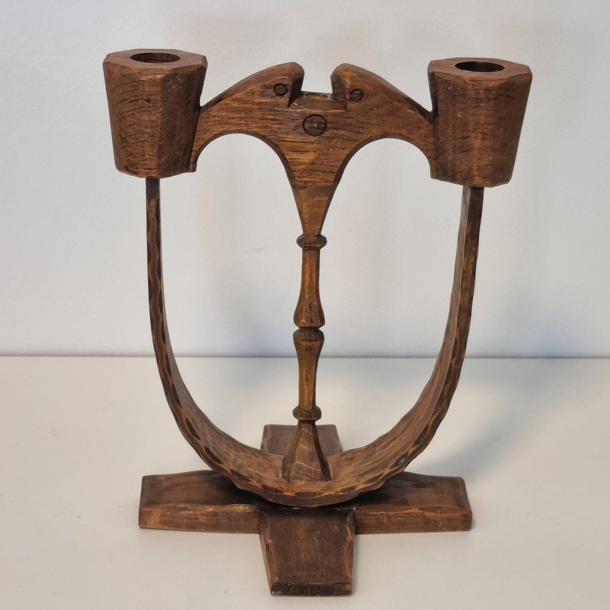 A wooden sculpture with a curved, organic shape and a textured surface.