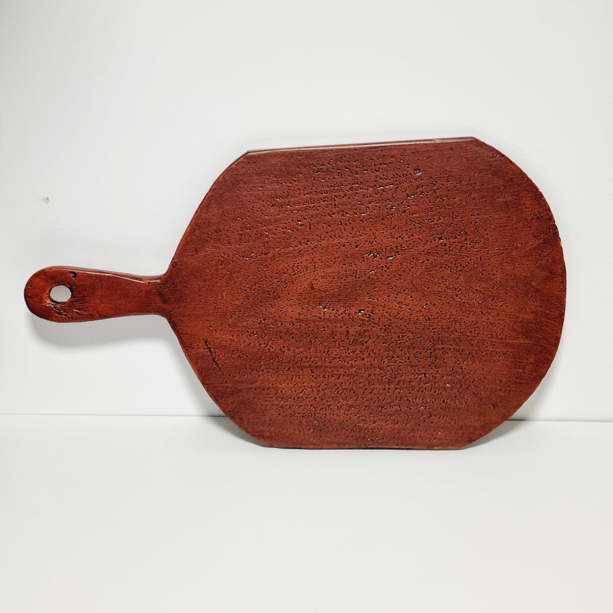 Antique Swedish painted bread board hanging on a wall as folk art decor