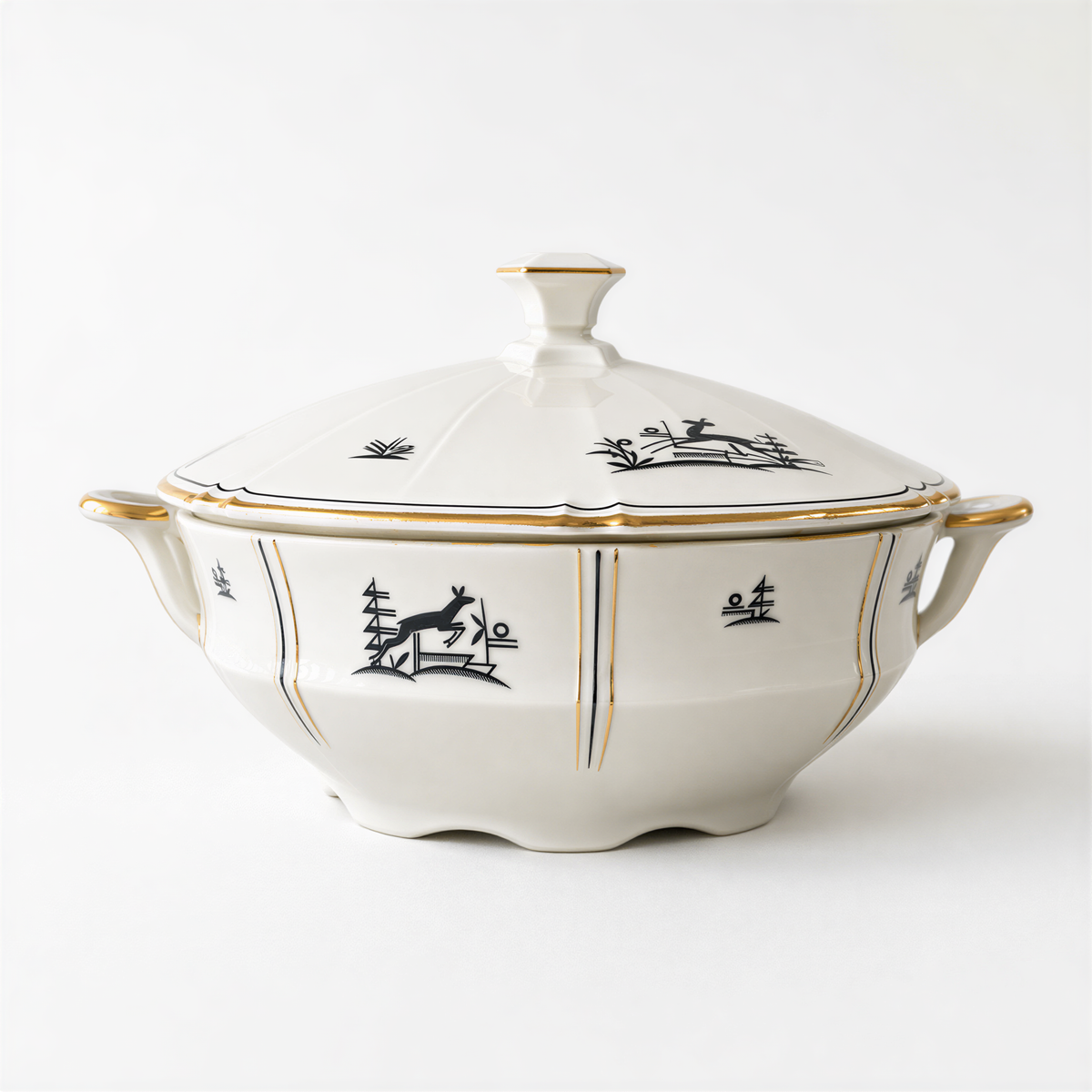 A white ceramic bowl with gold trim and black and white designs on it.
