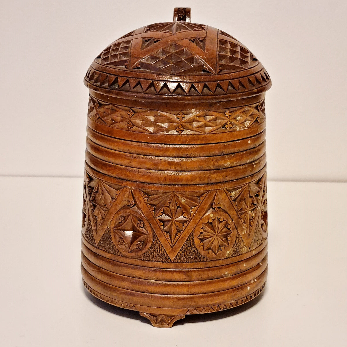 Chip carved geometric pattern around the body of 1875 wooden tankard