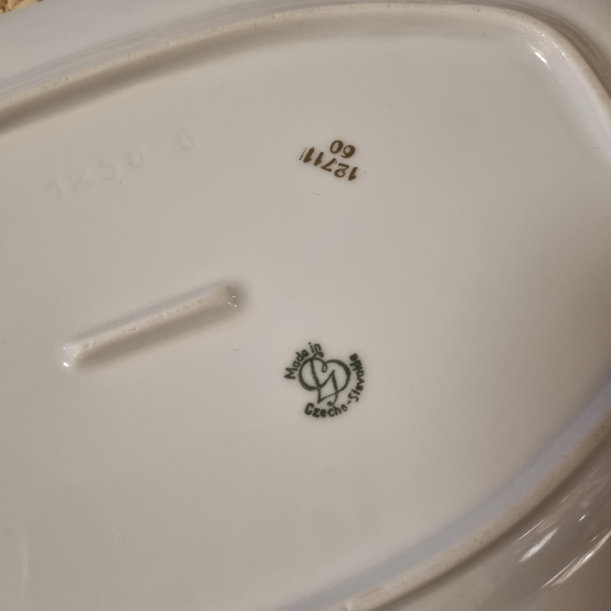 a close-up view of a white ceramic plate or bowl, with some text and numbers visible on it.