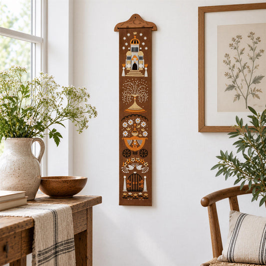 a cozy corner of a room with a wooden table, a vase of flowers, and a decorative wall hanging.