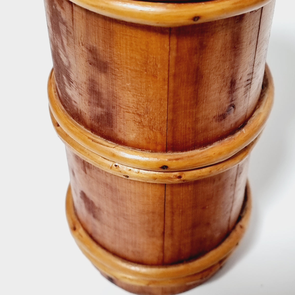 Close-up of honey-colored split-branch hoops on churn