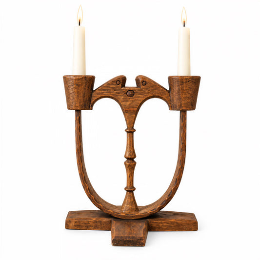 A wooden candlestick holder with two candles on top, designed in a unique and artistic manner.